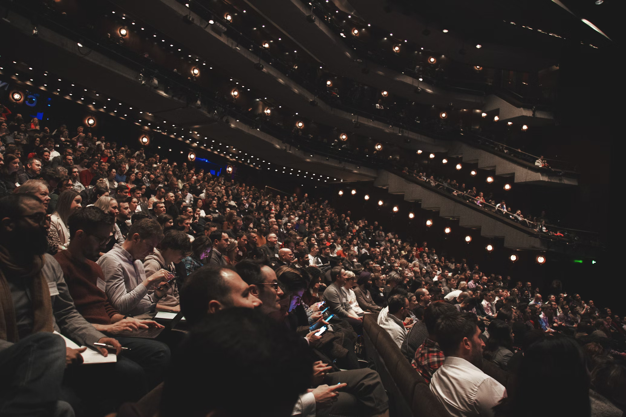 Professionals seated in an auditorium.